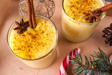 Traditional Christmas drink eggnog on a wooden background  - obrazy, fototapety, plakaty