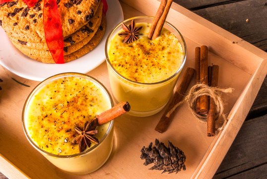 Traditional Christmas drink eggnog on a wooden background 