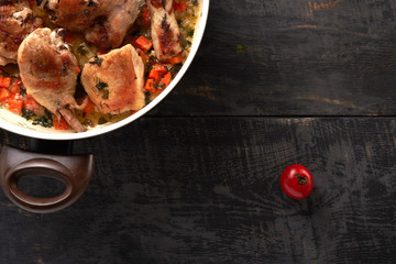 pieces of fried chicken with vegetables on a wooden table