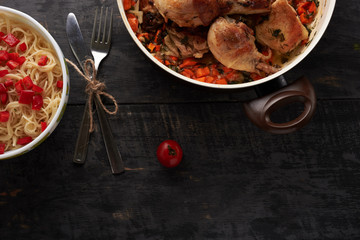 pieces of fried chicken with vegetables and pasta on a able