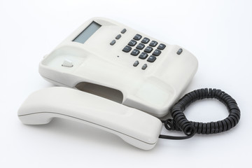 White telephone with push buttons on white background
