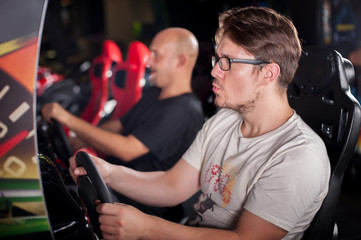 Man playing driving wheel video game