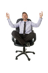 young attractive happy businessman relaxing with hands in yoga position sitting on office chair