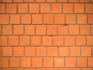 Wall made with big red square bricks.
