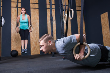 Fototapeta premium functional fitness workout at the gym with rings push up