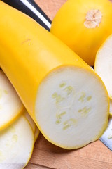 Sliced zucchini and knife on a wooden board, closeup