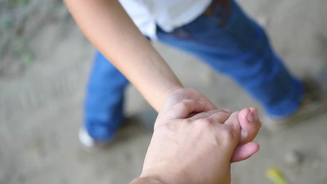 the child goes with mom holding his hand