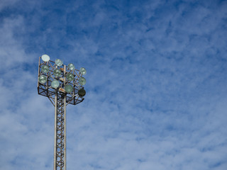 Old and tall spotlights tower at sports stadium