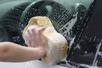 Close-up of children children washing the car