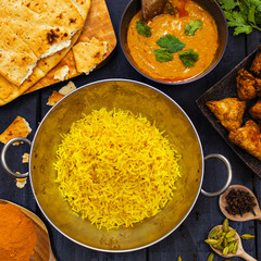 Indian pilau rice in balti dish served with chicken tikka masala