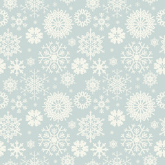 Cute seamless pattern with snowflakes isolated on light blue bac