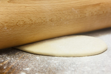 Preparation of the dough. Cook rolls out the  on the Board.