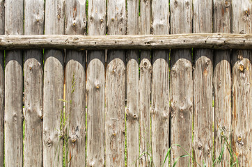 Grey wooden fence. Of logs.