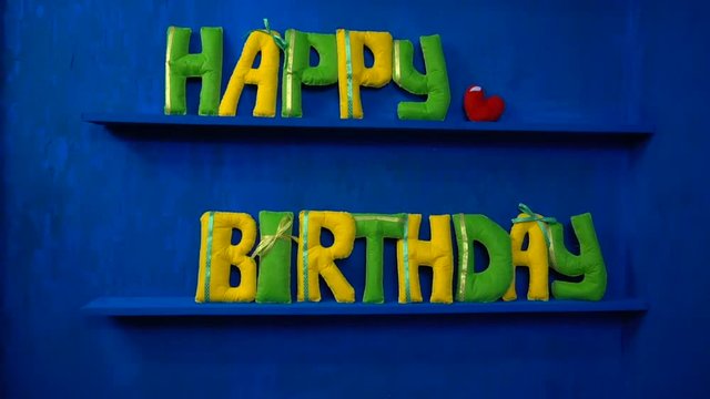Happy Birthday from felt letters on blue background