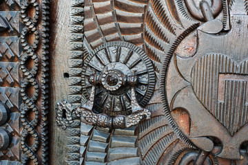 Detail of a very old iron metal door, knocker.