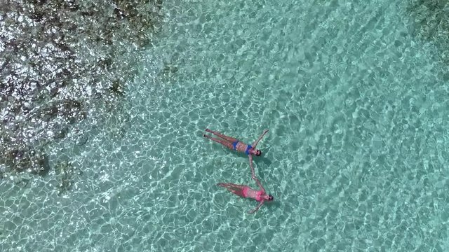 aerial view of women floating on the water at the beach, Lindquist beach, St Thomas, United States Virgin Islands