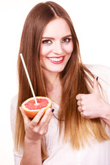 Woman holds grapefruit drinking juice from fruit
