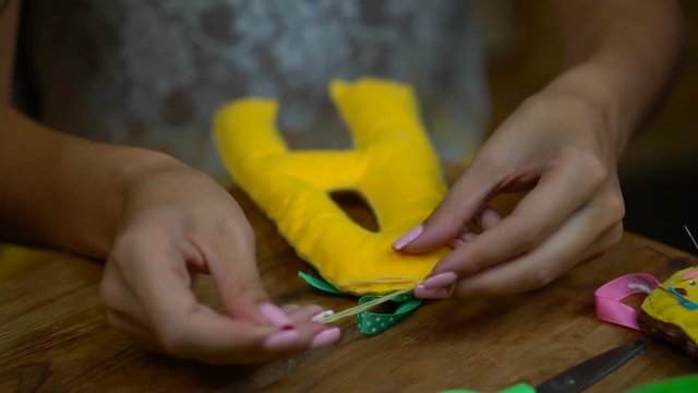 Handmade girls sewing letters of felt