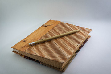 pencil and entic book on white backgrounds