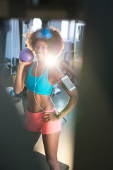 Portrait of pretty fit girl in sport clothes with balance ball i