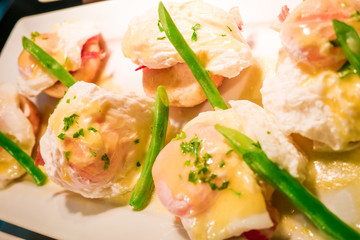 Eggs Benedict- toasted English muffins, ham, poached eggs aspara