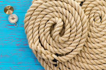 Two neatly coiled ropes and a magnetic compass