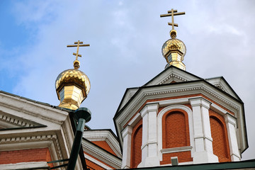Fototapeta na wymiar Gilded domes and crosses over church