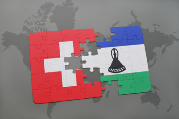 puzzle with the national flag of switzerland and lesotho on a world map background.