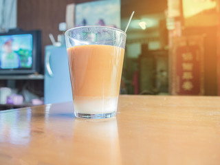 Hot tea cup on wooden table in asian cafe
