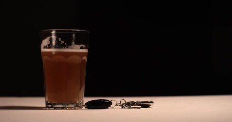Car keys tossed in front of beer mug - Powered by Adobe