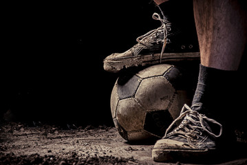 Ragged sneakers with a soccer ball