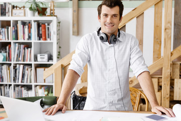 Young man standing in creative office