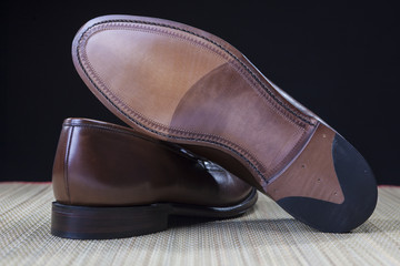 Footwear Concepts and Ideas. Backside View of Penny Loafer Natural Leather Sole Closeup