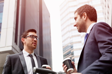 Two businessmen talking outdoors