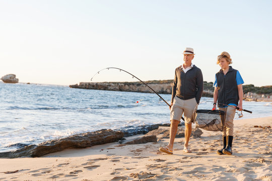 Senior Man Fishing With His Grandson