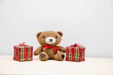 Bear is sitting with gift box for Christmas party