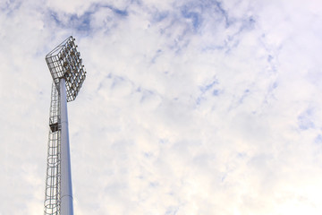 Obraz premium Lighting tower of stadium on sky and cloud background.