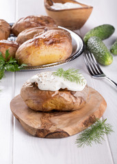 Baked potato topped with sour cream sauce