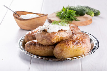 Baked potato topped with sour cream sauce