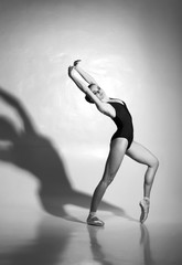 Graceful ballerina dancing in a studio