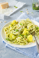 Spaghetti with  potatoes and classic italian pesto sauce. Selective focus.