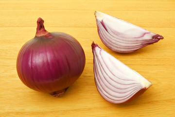 Red onions on a wooden background