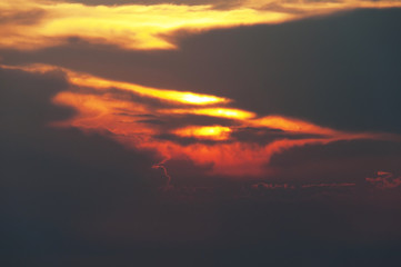 sunset on mountain, subject is blurred and low key
