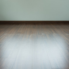 empty room interior, brown wood laminate floor and white mortar