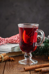 Mulled wine with spices on dark background