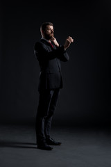 Businessman writing imaginary text on a dark background