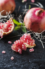Sweet ping pomegranate on the black table