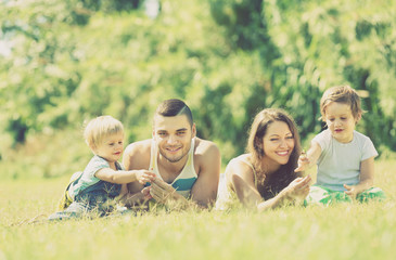 Fototapeta na wymiar Family of four in sunny park