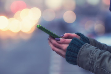 Using cellphone with defocused city lights.