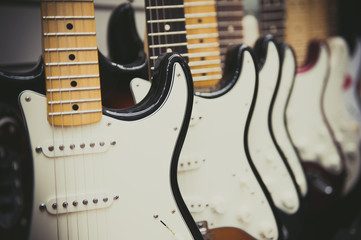 Fototapeta premium Many electric guitars body aligned in the store